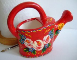 Miniature red decorative watering can