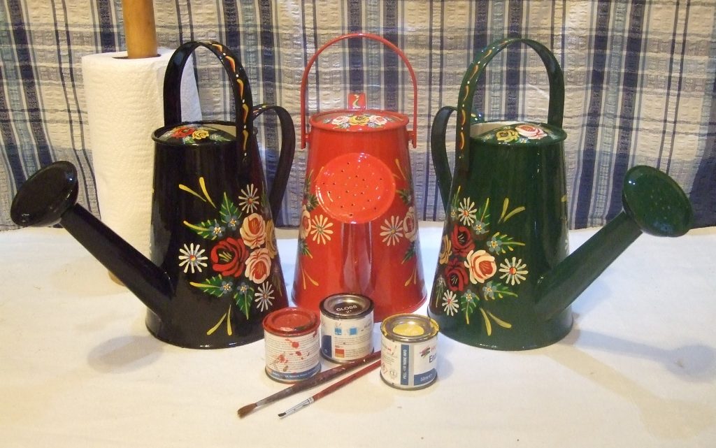 Watering cans in red, green and black